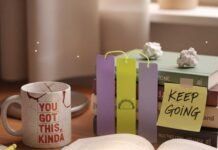 The 8 Best Self Improvement Books to Read in 2025 Cluttered desk with a glowing book and a mug.