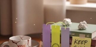 The 8 Best Self Improvement Books to Read in 2025 Cluttered desk with a glowing book and a mug.