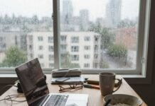 Free Printable Goal Setting Worksheet for 2025 Person working on goals at a rainy window.