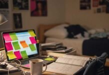 Success Tips for Students: What I Wish I Knew in College Messy dorm desk with laptop, notes, and coffee.